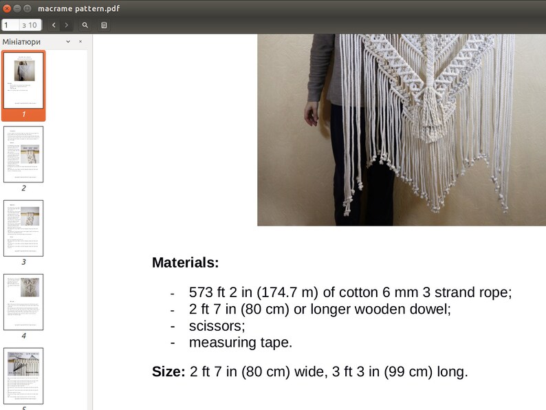 May include: A white macrame wall hanging with a geometric pattern. The hanging is 2 feet 7 inches wide and 3 feet 3 inches long. The materials needed to make this hanging are 573 feet 2 inches of cotton rope, a wooden dowel, scissors, and measuring tape.