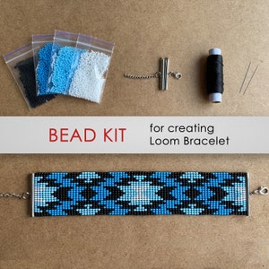 May include: Bead kit for creating a loom bracelet. The kit includes black, white, and blue beads, black thread, two needles, a silver clasp, and a silver chain.