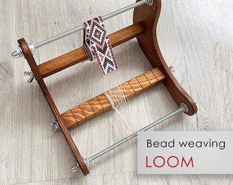 May include: A wooden bead weaving loom with a beaded bracelet in progress. The loom has two adjustable metal rods and a wooden base with slots for the beads. The text "Bead weaving LOOM" is printed on the image.