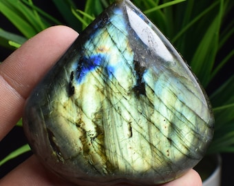 May include: A heart-shaped labradorite crystal with iridescent blue, green, and gold hues. The crystal is polished and has a smooth surface.