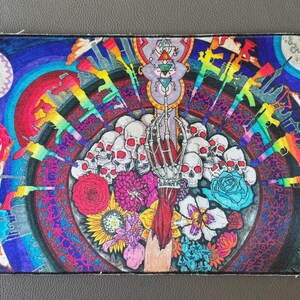 May include: Colorful patch featuring a central design of skulls, flowers, and a skeletal hand. Rainbow-colored guns encircle the central image. The background is a mix of blues, purples, and reds, with circular and floral patterns. Includes Tibetan script.