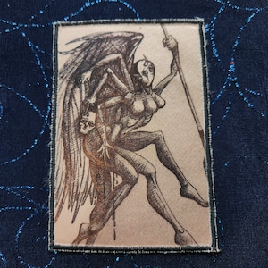 May include: A black and white illustration of a winged figure with multiple arms and legs, holding a spear. The figure is depicted in a dynamic pose, with wings spread and legs outstretched. The background is a light beige color.