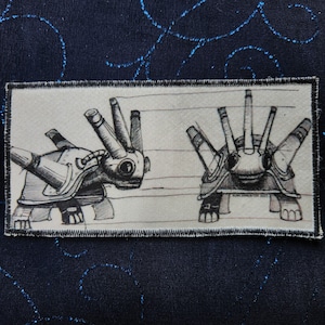 May include: A black and white illustration of two stylized, futuristic, armored turtles with multiple spiky protrusions on their shells. The turtles are drawn on a lined background.