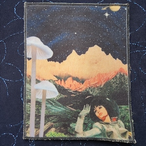 May include: A retro-style collage featuring a woman in a silver spacesuit, looking up at a starry sky with a mountain range in the background. Two white mushrooms are in the foreground.