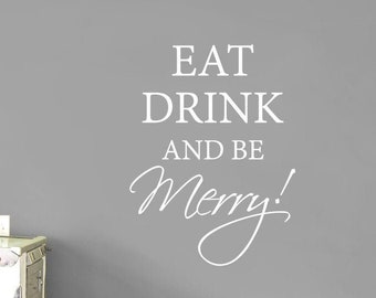 May include: A wall decal featuring the white text EAT DRINK AND BE Merry! in a combination of serif and script fonts. The lettering is applied to a solid gray wall surface, creating a high-contrast display of the phrase in a centered layout.