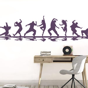 May include: A purple wall decal featuring a horizontal row of eight silhouettes of people in various dynamic dance poses. Each figure is depicted in a different motion, ranging from lunges and jumps to crouches, all aligned on a straight line.