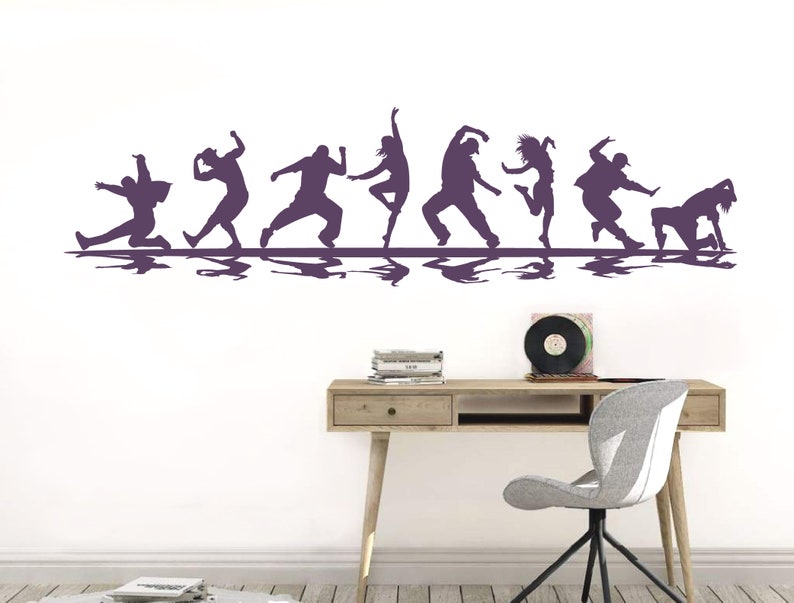 May include: A purple wall decal featuring a horizontal row of eight silhouettes of people in various dynamic dance poses. Each figure is depicted in a different motion, ranging from lunges and jumps to crouches, all aligned on a straight line.