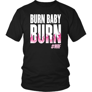 May include: Black t-shirt with the words "BURN BABY BURN" in large white letters. Pink flames are incorporated into the word "BURN". The hashtag "#MBF" is below the flames.