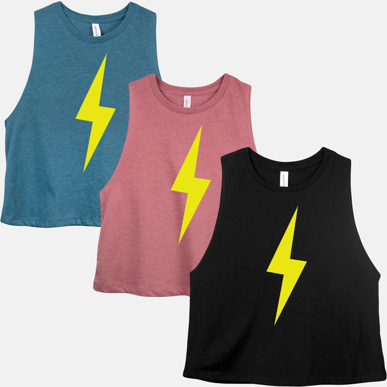 May include: Three sleeveless crop tops in teal, dusty rose, and black. Each top features a large yellow lightning bolt graphic on the front. The tops have a scoop neck and a relaxed fit, suitable for casual wear.