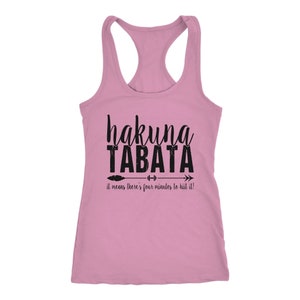 May include: A light pink racerback tank top with the words "hakuna TABATA" in black script and block letters. Below the text is an arrow with a feather and weights, and the phrase "it means there's four minutes to HIIT it!"
