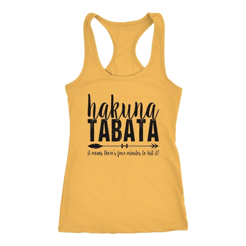May include: Mustard yellow racerback tank top with the words "hakuna TABATA" in black script and block letters. Below the text is an arrow with the words "it means there's four minutes to hit it!"