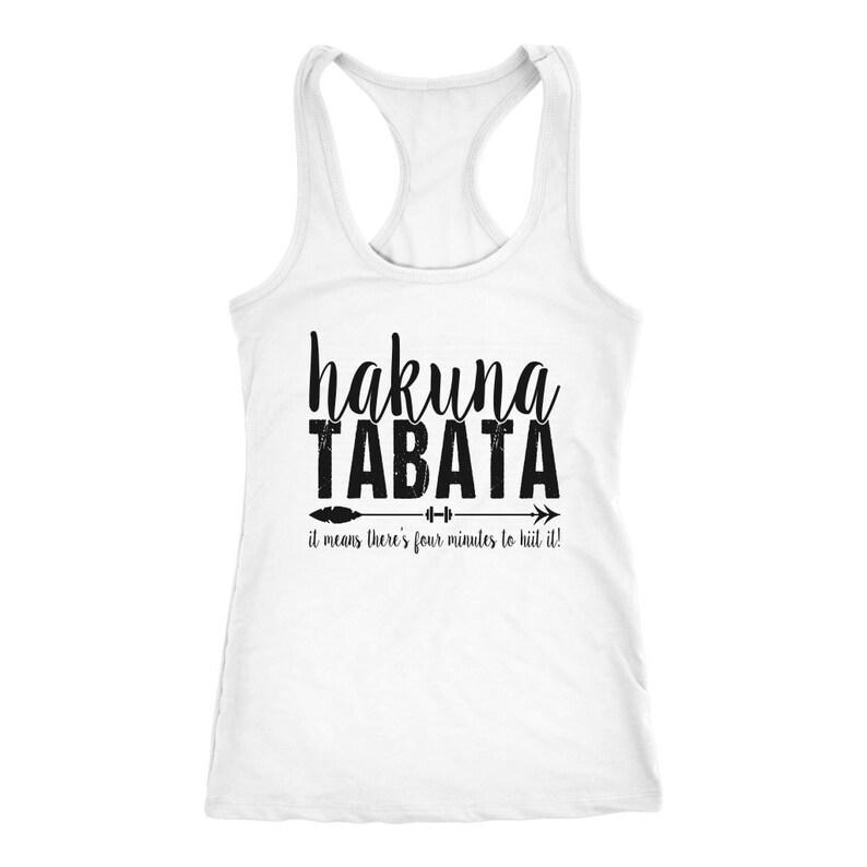 May include: White racerback tank top with the words "hakuna TABATA" in black script and block letters. Below the text is an arrow with a dumbbell graphic, and the phrase "it means there's four minutes to hiit it!"