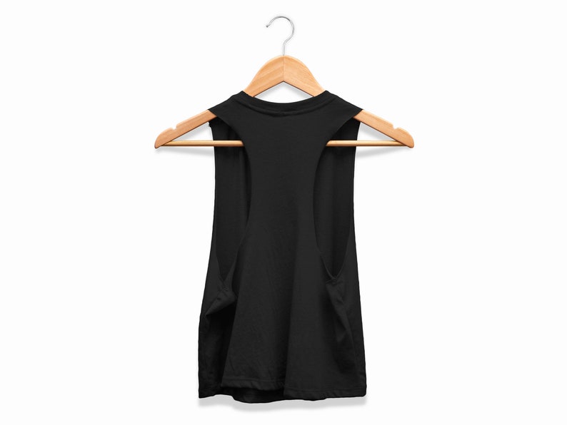 May include: A black vest top suspended from a wooden clothes hanger. The top features a scoop neckline and wide armholes. The background is plain white.