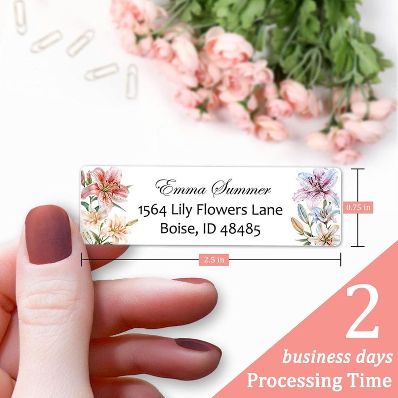 May include: White return address label with a floral design featuring pink and purple lilies. The label includes the text "Emma Summer", "1564 Lily Flowers Lane", "Boise, ID 48485". The label measures 2.5 inches wide and 0.75 inches tall.