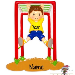 May include: A personalized Christmas ornament featuring a boy in a yellow shirt and blue shorts hanging from a red and white jungle gym. The ornament has the words "Year" and "Name" on it.