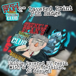 May include: A 2-inch layered print pin badge featuring a cartoon character with glasses and a red tie. The pin has the text "GRUNKLE STAN'S TRIANGLE PUNCHING CLUB" and "Unique layered UV resin with a fully detailed, 3D design!"