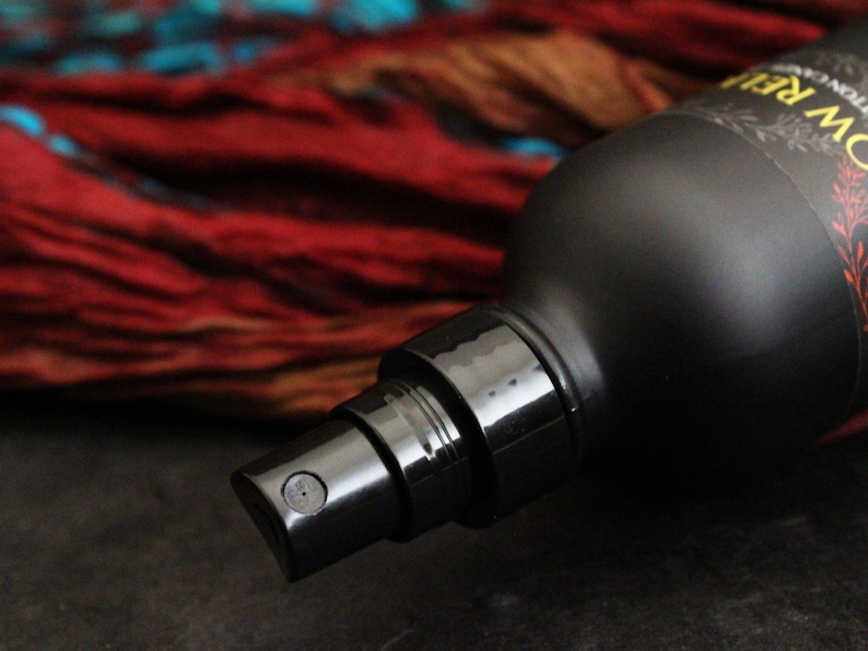 May include: A black spray bottle with a black nozzle and a label that reads "ROW RELIE", with a red and orange background.