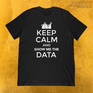 May include: Black t-shirt with a white graphic design. The graphic features a stylised chart with a crown on top and the text "Keep Calm and Show Me The Data".