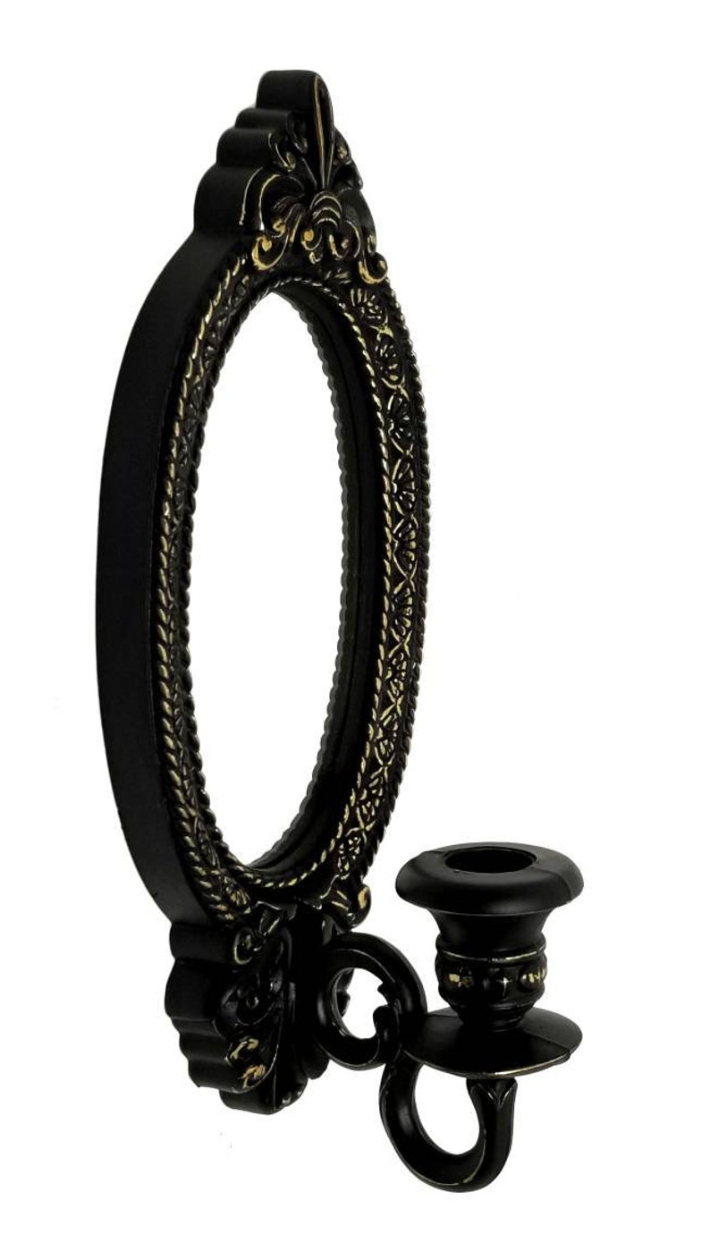 May include: Black oval wall mirror with ornate gold accents and a single candle holder attached to the side.