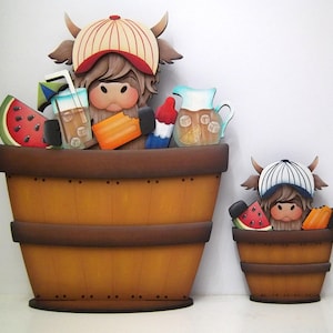 May include: Wooden Highland cow decorations in a barrel, wearing a baseball cap. The large barrel has a watermelon slice, a drink with ice, and a popsicle. The smaller barrel has a watermelon slice and a popsicle.