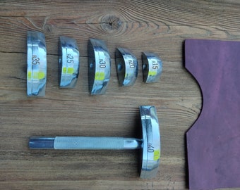 May include: Set of six metal leather working tools with rounded edges and handles. The tools are labelled with different sizes: R15, R20, R25, R30, R35, and R40.