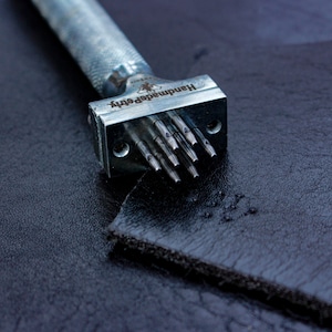 hand punch for punching eight 0.04 inch diameter holes