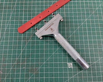 Hand punch for belt