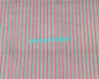 May include: Pink and teal striped fabric with a white stripe running through the center of each color stripe. The fabric has a subtle texture and is likely cotton. The text "blockprintjaipur" is printed in the center of the fabric.