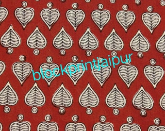 May include: Red fabric with a white and black leaf pattern. The fabric is printed with the text "block print jaipur".