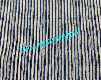 Pode incluir: Têxtil com um padrão repetitivo de listras verticais em branco sujo e azul marinho. O texto "blockprintjaipur" é sobreposto no tecido em turquesa. O tecido parece ser de algodão ou linho.