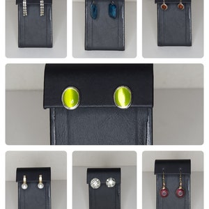 May include: Assortment of earrings displayed on black stands. The earrings are made of various materials, including silver, gold, and crystals. The earrings are in different styles, including studs, drops, and hoops.
