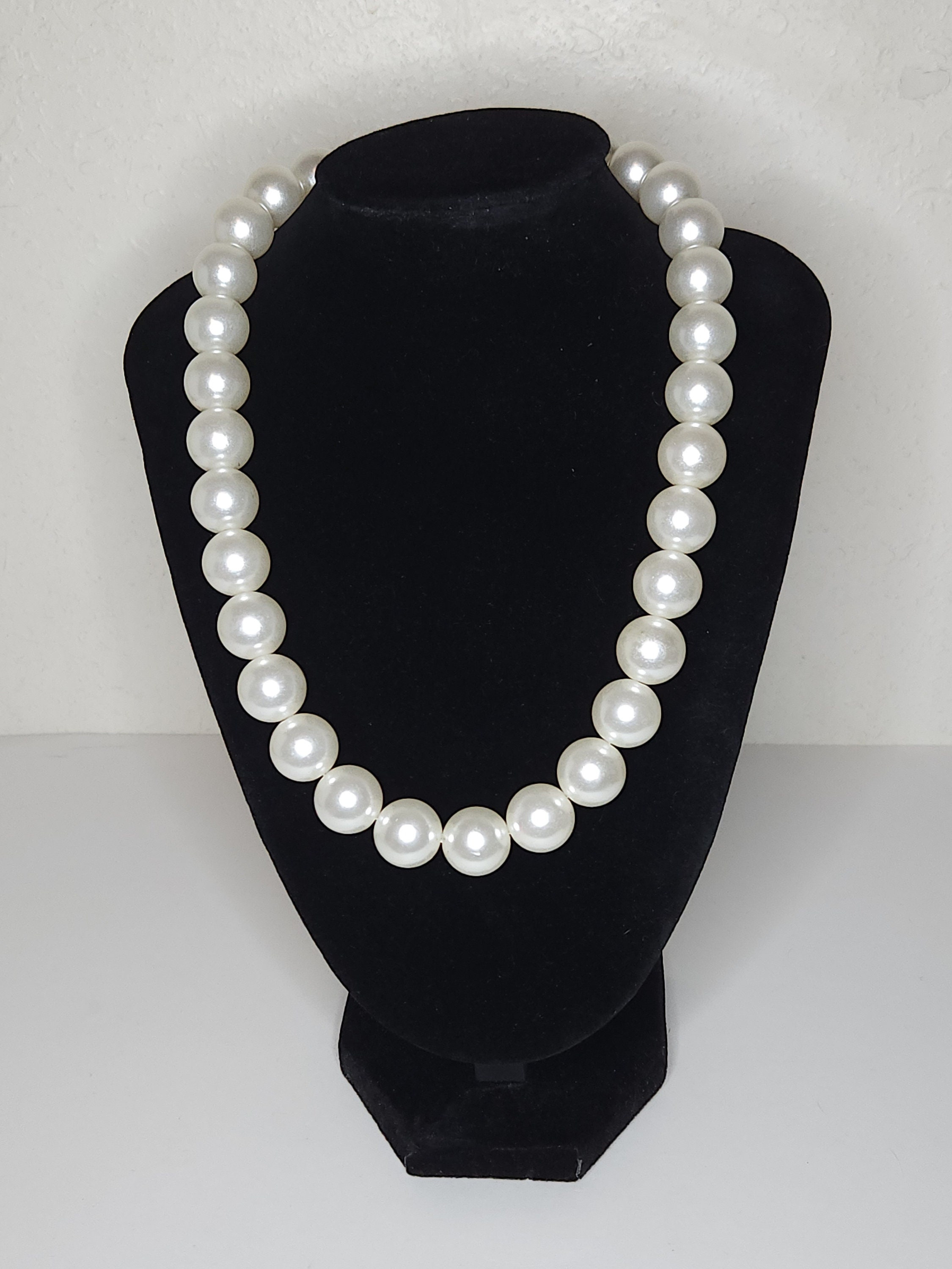 Chanel: A Faux Pearl Necklace with Large Crystal-Bow