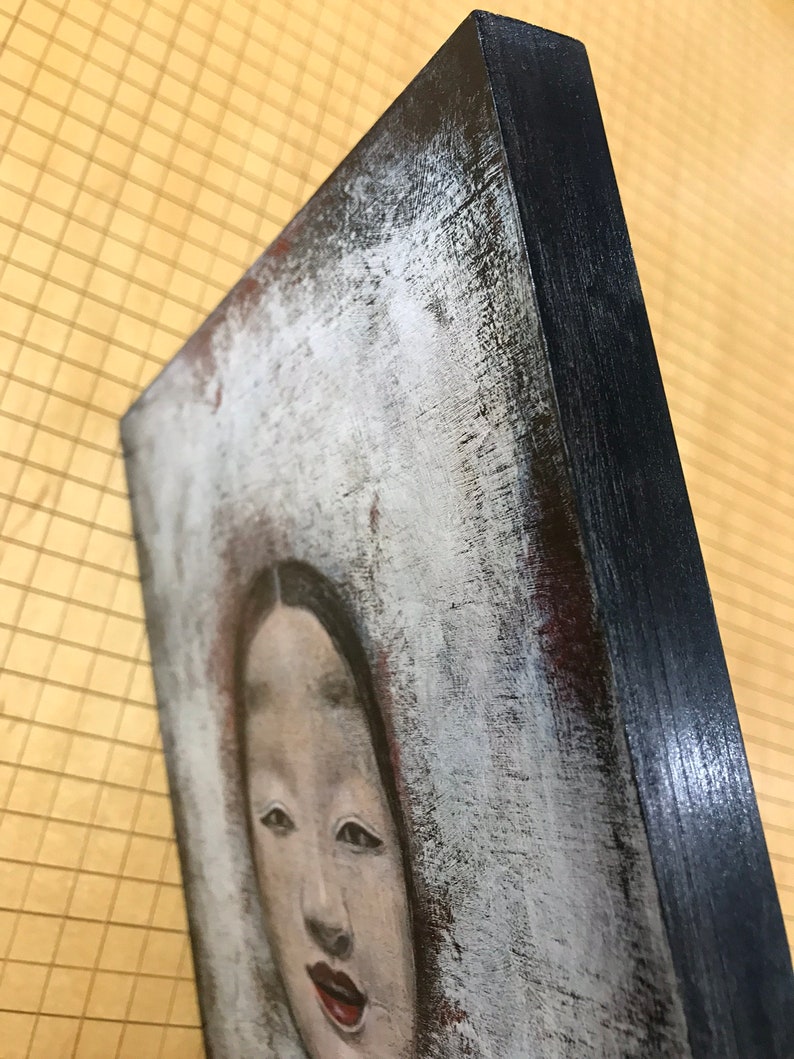 K&ouml;nnte beinhalten: Eine Nahaufnahme eines Gem&auml;ldes mit dem Gesicht einer Frau. Die Frau hat dunkles Haar und tr&auml;gt ein wei&szlig;es Kleid. Das Gem&auml;lde ist auf einer Leinwand mit einem schwarzen Rahmen.