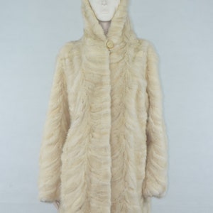 May include: A white fur coat with a hood. The coat has a button closure and a slightly flared silhouette.