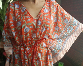 May include: A short, orange and blue floral print kaftan with a drawstring waist and ruffled sleeves.