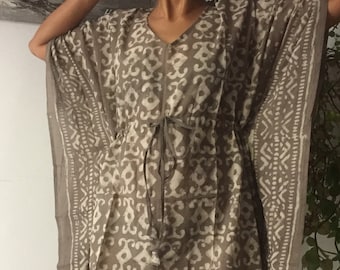 May include: A brown and white patterned kaftan with a tie at the waist.