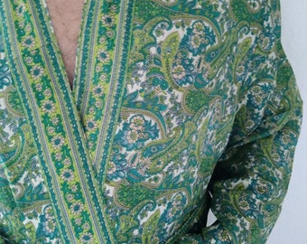 May include: A green and white paisley patterned robe with a long sleeve and a sash tie.