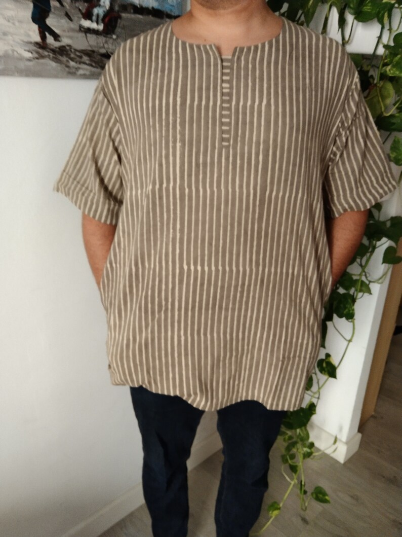 May include: A brown and white striped short-sleeved shirt with a button-up collar.