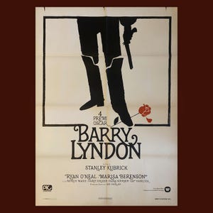 May include: A white ceramic mug with a black handle and the text "But First, Coffee" in a bold, black font. The mug is set against a blurred background, suggesting a cozy setting. The mug appears to be approximately 4 inches tall.