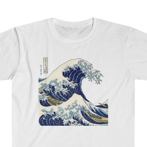May include: White t-shirt with a blue and white print of a large wave crashing. The print is a famous Japanese woodblock print called "The Great Wave off Kanagawa" by Katsushika Hokusai.