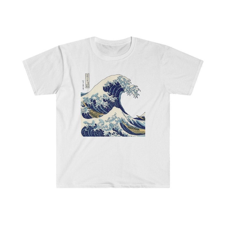May include: White t-shirt with a blue and white print of a large wave crashing. The print is a famous Japanese woodblock print called "The Great Wave off Kanagawa" by Katsushika Hokusai.