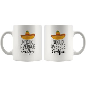 May include: Two white ceramic coffee mugs with black text that reads "Nacho Average Golfer" and a cartoon sombrero on each mug.