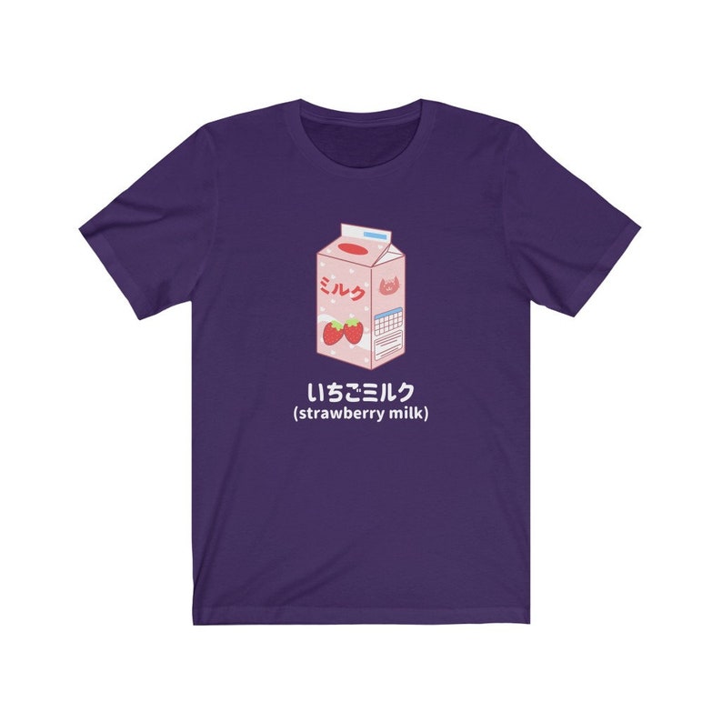 May include: Purple t-shirt with a cartoon illustration of a carton of strawberry milk. The carton is pink and white with the Japanese word for milk, "ミルク", and the text "いちごミルク (strawberry milk)".