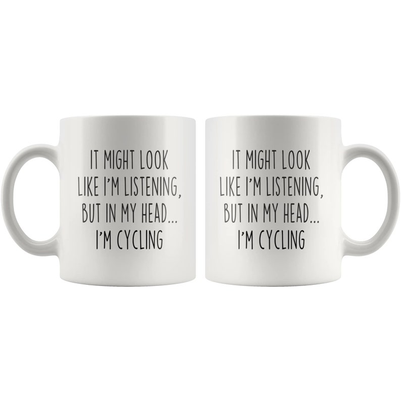 May include: White ceramic coffee mug with a black text design that reads "It might look like I'm listening, but in my head... I'm cycling."