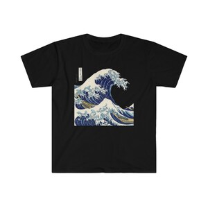 May include: Black t-shirt with a graphic print of a large blue wave crashing over a boat. The wave is depicted in a traditional Japanese style.