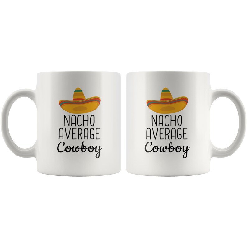 May include: Two white ceramic mugs with black text that reads "Nacho Average Cowboy" and a cartoon sombrero on each mug.