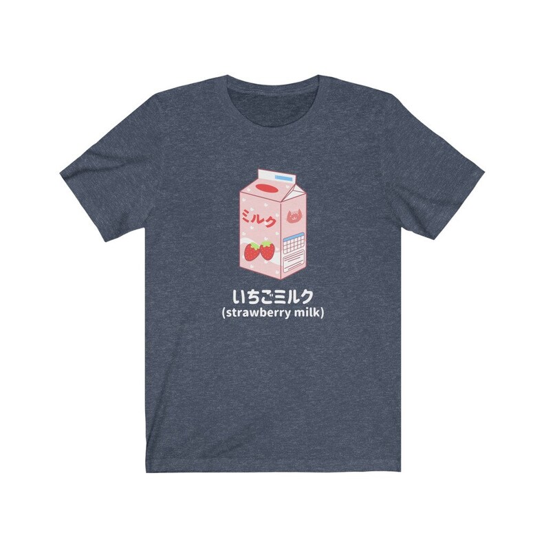 May include: A navy blue t-shirt with a cartoon illustration of a pink carton of strawberry milk. The carton has Japanese text that says "Milk" and "Strawberry Milk".