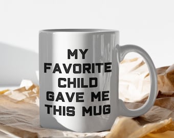 May include: White ceramic mug with black text that reads "My Favorite Child Gave Me This Mug".