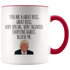 May include: White coffee mug with a red rim and handle. The mug features a black and white illustration of Donald Trump and the text "You are a great boss, great boss. Very special, very talented. Everyone agrees. Believe me."