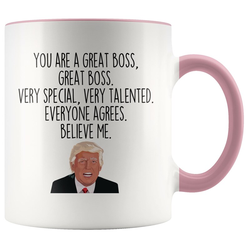 May include: White ceramic coffee mug with a pink rim and handle. The mug features a black and white image of a man with the text "You are a great boss, great boss. Very special, very talented. Everyone agrees. Believe me."